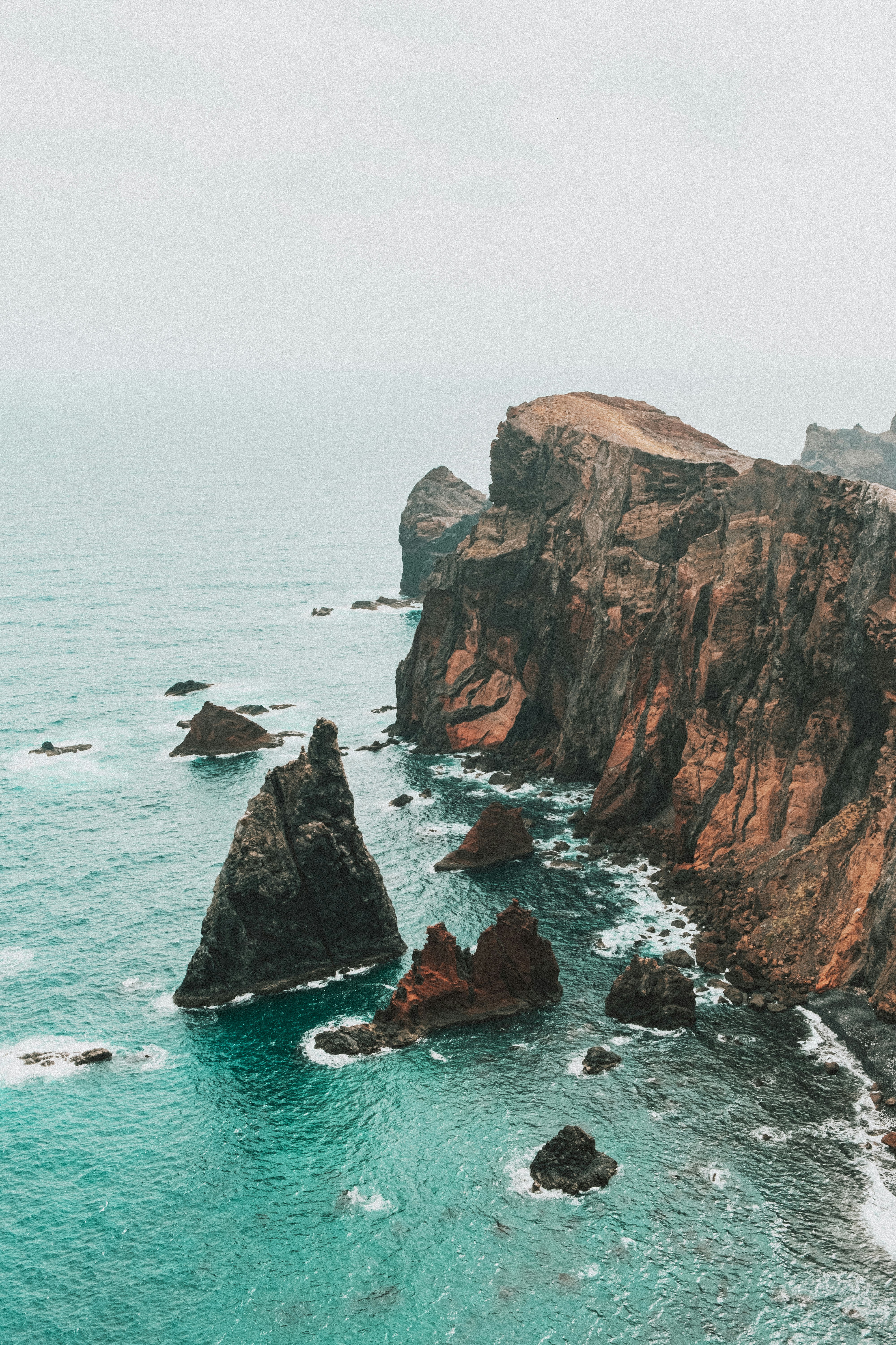 brown rock formation on sea during daytime